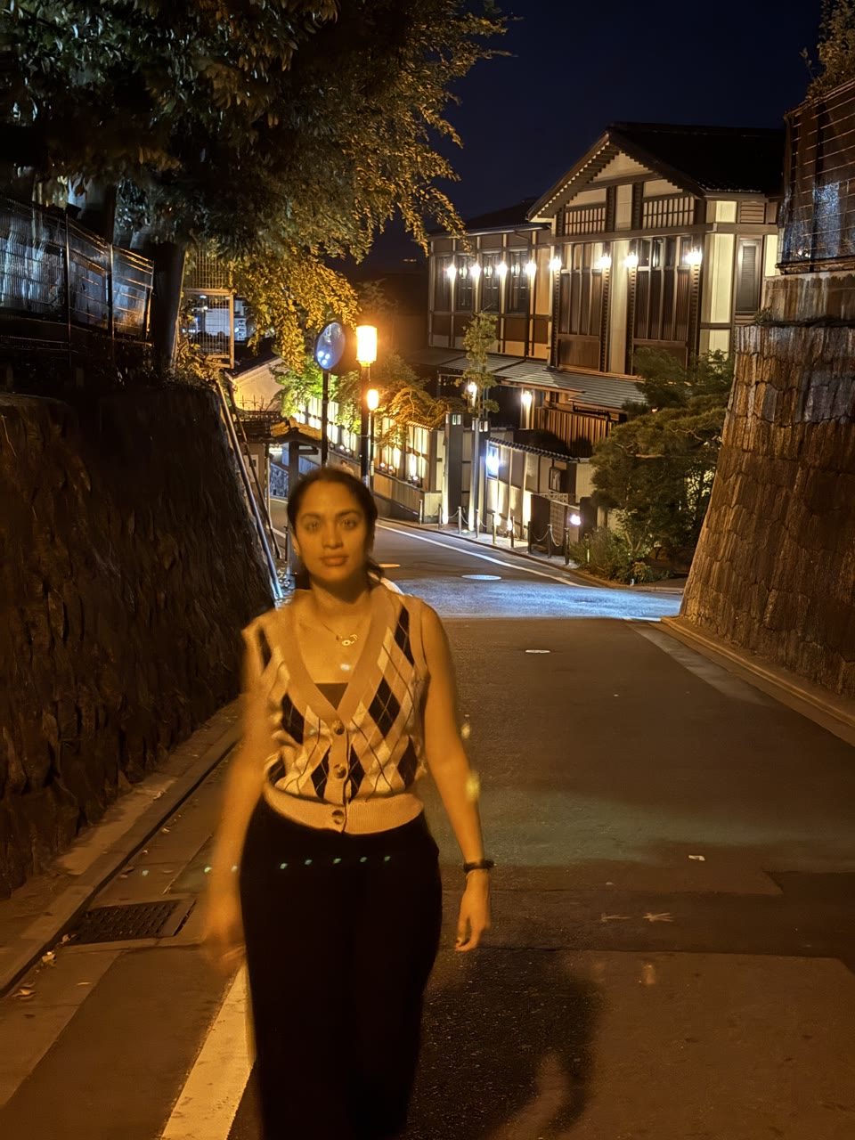 Hazel Mohamedali on an evening walk in Japan Hazel Mohamedali walking along a lantern-lit street in Japan