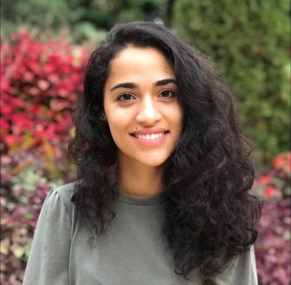 Garden portrait of Hazel Mohamedali Hazel Mohamedali smiling in a garden portrait