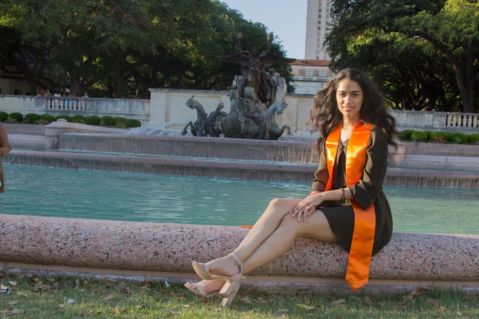 Hazel Mohamedali at the UT Austin fountain Hazel Mohamedali seated by the UT Austin fountain on graduation day