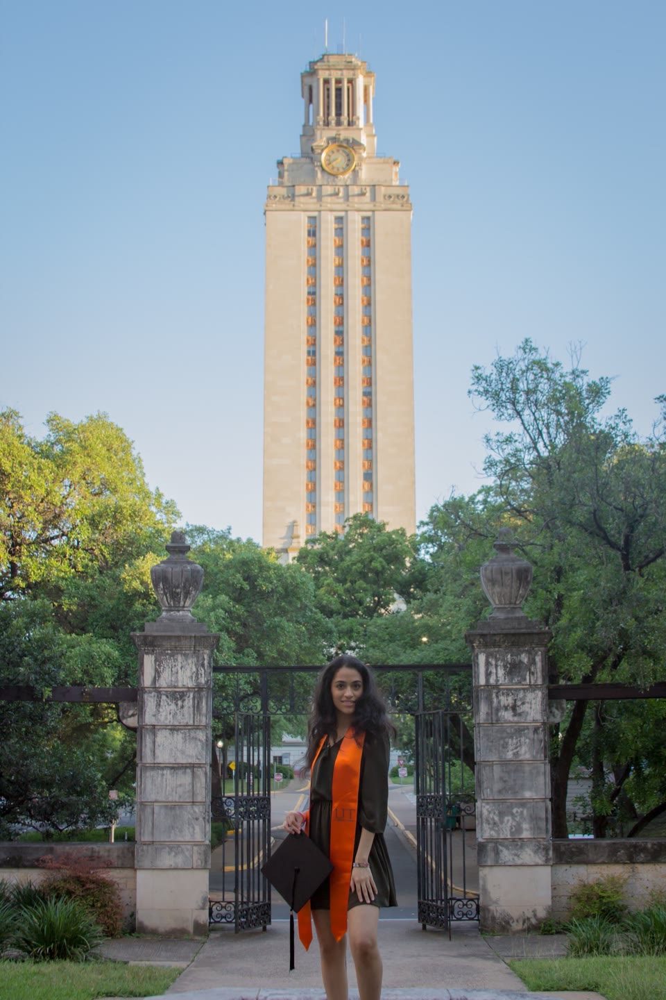 Hazel Mohamedali at the UT Tower Hazel Mohamedali in graduation regalia at the UT Tower